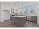 Well-lit kitchen featuring stainless steel appliances, a large island, and white cabinets at 1779 Beckham Ne Pl # 58, Atlanta, GA 30324