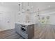 Spacious living room with a kitchen island, recessed lighting, and hardwood floors at 1779 Beckham Ne Pl # 58, Atlanta, GA 30324