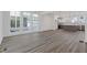 Open living room with hardwood floors, large windows, and a view of the modern kitchen at 1779 Beckham Ne Pl # 58, Atlanta, GA 30324