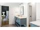 This bathroom features a blue vanity with marble countertop, modern fixtures and opens to the main bedroom at 2641 Drew Valley Ne Rd, Brookhaven, GA 30319