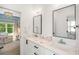 Bright bathroom with marble countertops, modern fixtures, and a doorway view of a Bedroom at 2641 Drew Valley Ne Rd, Brookhaven, GA 30319