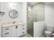 Modern bathroom featuring a walk-in shower, white vanity with storage, and sleek fixtures at 2641 Drew Valley Ne Rd, Brookhaven, GA 30319