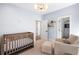 Inviting Bedroom features crib, chair, and ottoman, all bathed in light from the bright windows at 2641 Drew Valley Ne Rd, Brookhaven, GA 30319