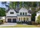 Beautiful two-story white farmhouse exterior with black accents and a well-manicured lawn at 2641 Drew Valley Ne Rd, Brookhaven, GA 30319