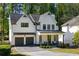 Charming two-story modern farmhouse with black framed windows and a gray driveway at 2641 Drew Valley Ne Rd, Brookhaven, GA 30319