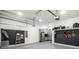 Spacious garage featuring a refrigerator, cabinets, and slat wall storage at 2641 Drew Valley Ne Rd, Brookhaven, GA 30319