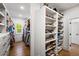 Spacious walk-in closet with custom shelving for ample storage and organization of clothes and shoes at 2641 Drew Valley Ne Rd, Brookhaven, GA 30319