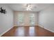 Spacious bedroom with two large windows, ceiling fan, and hardwood floors at 1244 Weatherstone Ne Dr, Atlanta, GA 30324