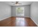 Bright bedroom featuring hardwood floors, ceiling fan, and large window at 1244 Weatherstone Ne Dr, Atlanta, GA 30324