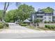 Community entrance with mature trees, landscaping and sign for Weatherstone Condominiums at 1244 Weatherstone Ne Dr, Atlanta, GA 30324