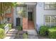 Charming townhouse exterior featuring well-maintained landscaping and a welcoming entryway with brick accents at 1244 Weatherstone Ne Dr, Atlanta, GA 30324