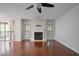Bright living room featuring hardwood floors, a cozy fireplace, and a ceiling fan at 1244 Weatherstone Ne Dr, Atlanta, GA 30324