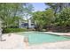 Outdoor pool at Weatherstone Condominiums with seating, surrounded by lush trees at 1244 Weatherstone Ne Dr, Atlanta, GA 30324