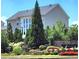 Exterior view of home with mature trees and manicured landscaping surrounding the property at 134 Sierra Cir, Woodstock, GA 30188