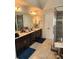 Elegant bathroom featuring dual sinks, dark cabinets, and a modern glass-enclosed shower, providing a spa-like experience at 134 Sierra Cir, Woodstock, GA 30188