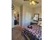 Cozy bedroom featuring a ceiling fan, bedside table, and an en-suite bathroom with modern fixtures at 134 Sierra Cir, Woodstock, GA 30188