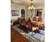 Elegant dining room with hardwood floors, decorative rug, chandelier, and wainscoting at 134 Sierra Cir, Woodstock, GA 30188