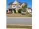 Beautiful brick two-story home boasts a manicured lawn, colorful flower beds and a welcoming entrance at 134 Sierra Cir, Woodstock, GA 30188