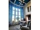 Bright living room featuring tall windows with custom blue drapes, lots of light, and decor at 134 Sierra Cir, Woodstock, GA 30188