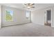 Spacious bedroom with plush carpet, a ceiling fan, and bright windows for natural light at 2861 Fareed, Douglasville, GA 30135