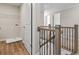 Hallway with wooden banister and wrought iron spindles, featuring a laundry area at 2861 Fareed, Douglasville, GA 30135