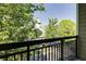 Apartment balcony looking out onto trees and a nearby building and parking lot at 4246 River Green Nw Dr # 202, Atlanta, GA 30327
