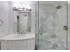 Bright bathroom with white vanity and glass shower featuring gray tile surround at 4246 River Green Nw Dr # 202, Atlanta, GA 30327