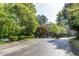 View of community entrance with trees and greenery at 4246 River Green Nw Dr # 202, Atlanta, GA 30327