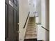 Entryway features a staircase with black handrails and modern black tile flooring at 4246 River Green Nw Dr # 202, Atlanta, GA 30327