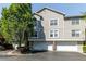 Charming townhome showcases a two-car garage and well-maintained landscaping on a bright sunny day at 4246 River Green Nw Dr # 202, Atlanta, GA 30327