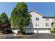 Charming townhome showcases a two-car garage and well-maintained landscaping on a bright sunny day at 4246 River Green Nw Dr # 202, Atlanta, GA 30327