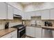 Functional kitchen with stainless steel appliances, tile backsplash, and well-lit cooking area at 4246 River Green Nw Dr # 202, Atlanta, GA 30327