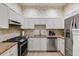 Modern kitchen with stainless steel appliances, granite countertops, and stylish white cabinetry at 4246 River Green Nw Dr # 202, Atlanta, GA 30327