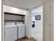 Convenient laundry closet with washer, dryer, and patterned wallpaper at 4246 River Green Nw Dr # 202, Atlanta, GA 30327