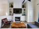 Cozy living room with fireplace, built-in shelving, and comfortable seating at 4246 River Green Nw Dr # 202, Atlanta, GA 30327
