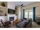 Cozy living room boasts a fireplace, custom built-ins, and a ceiling fan at 4246 River Green Nw Dr # 202, Atlanta, GA 30327