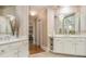 Elegant bathroom featuring double sinks, ample counter space, and a large mirror at 4855 Regency Sw Trce, Atlanta, GA 30331