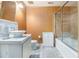 Clean bathroom featuring a white sink, toilet, and glass-enclosed tub/shower combination at 4855 Regency Sw Trce, Atlanta, GA 30331