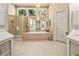 Bright bathroom with a large soaking tub, glass-enclosed shower, and double vanities at 4855 Regency Sw Trce, Atlanta, GA 30331