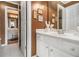 This bathroom boasts a white vanity with chrome fixtures and is tiled at 4855 Regency Sw Trce, Atlanta, GA 30331