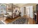 Spacious bedroom with a canopy bed, hardwood floors, and ample natural light at 4855 Regency Sw Trce, Atlanta, GA 30331