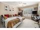 This neutral bedroom has a daybed, shutters, carpet and ceiling fan at 4855 Regency Sw Trce, Atlanta, GA 30331