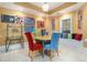 Bright breakfast nook features a round table, red and blue upholstered chairs, and vibrant artwork at 4855 Regency Sw Trce, Atlanta, GA 30331