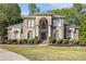 Beautiful two-story brick home with manicured lawn and an arched entryway with double doors at 4855 Regency Sw Trce, Atlanta, GA 30331