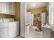 Convenient laundry room with washer, dryer, storage cabinets and natural light at 4855 Regency Sw Trce, Atlanta, GA 30331