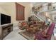 Comfortable living room with plush sofas, large TV, and open staircase at 4855 Regency Sw Trce, Atlanta, GA 30331