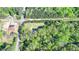 Aerial shot showing the home surrounded by lush greenery and the surrounding neighborhood with access roads at 5800 S Richland Creek Rd, Buford, GA 30518