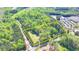An aerial view shows the property outlined in yellow, surrounded by lush greenery and nearby buildings at 5800 S Richland Creek Rd, Buford, GA 30518