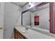 Bathroom with long countertop, cabinet, and large mirror showing a view to a pink bonus room at 5800 S Richland Creek Rd, Buford, GA 30518
