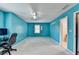 Bedroom with blue walls, neutral carpet, ceiling fan, and a single window with blinds at 5800 S Richland Creek Rd, Buford, GA 30518